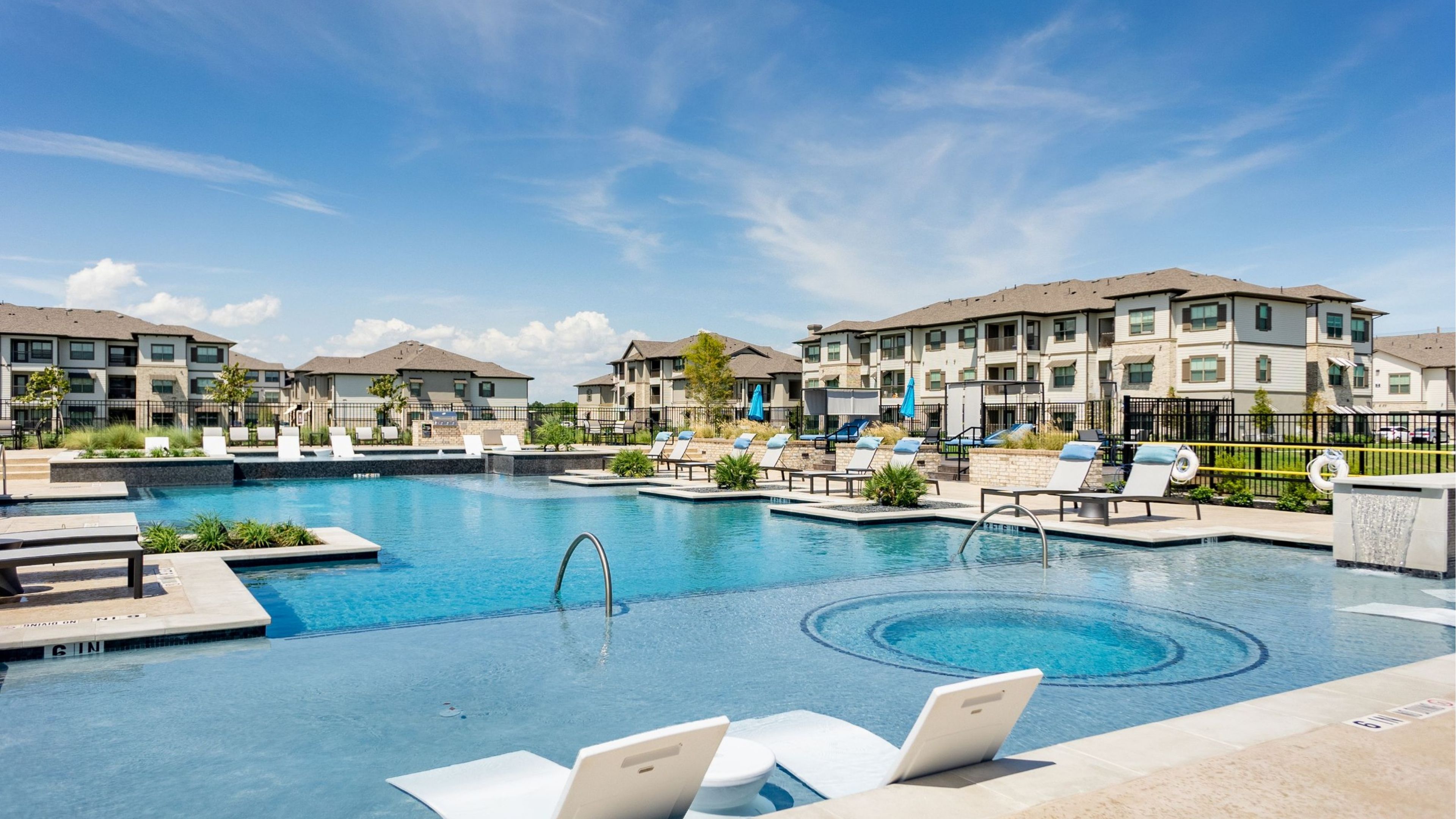 Hawthorne at Bay Forest apartments community exterior with outdoor hangout spot, lawn games, and picnic area