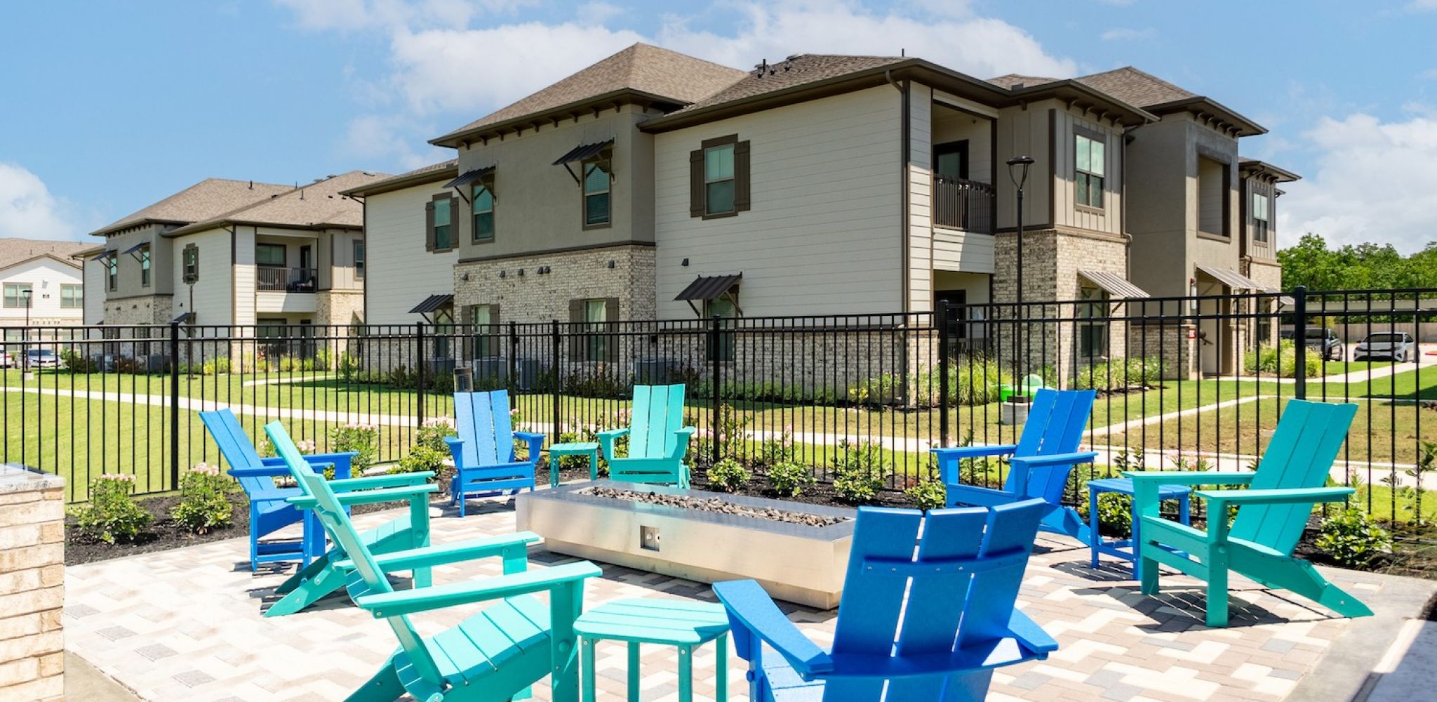 Hawthorne at Bay Forest apartments community exterior with outdoor fire pit and seating